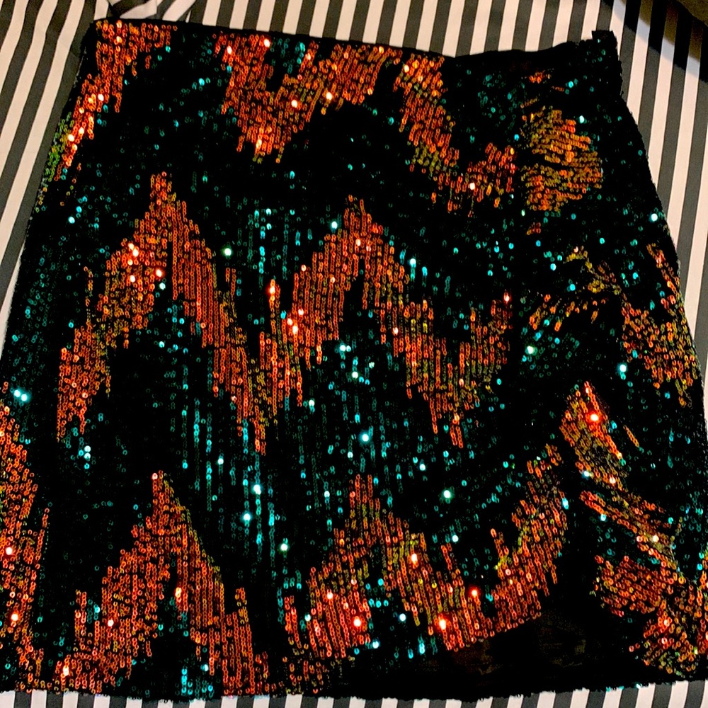 Sequence skirt with ruffle on the left side.